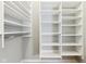 Spacious walk-in closet boasts hardwood floors, rod, and custom white shelving for optimal storage and organization at 645 Ellsworth St, Indianapolis, IN 46202
