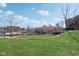 Picturesque waterfront view with a grassy area, colorful bridge, and relaxing seating at 645 Ellsworth St, Indianapolis, IN 46202