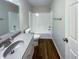 This bathroom features a bath tub and sink with gray counters and a white cabinet at 6454 Waterstone Dr, Indianapolis, IN 46268