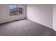 This bedroom features gray carpet and a window at 6454 Waterstone Dr, Indianapolis, IN 46268
