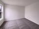 This bedroom has gray carpet and a window at 6454 Waterstone Dr, Indianapolis, IN 46268