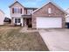 Charming two-story home featuring brick accents, a two-car garage, and a well-manicured front lawn at 6454 Waterstone Dr, Indianapolis, IN 46268