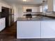 This kitchen features a gray island, white cabinets and stainless steel appliances at 6454 Waterstone Dr, Indianapolis, IN 46268