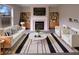 Bright living room with fireplace, built-in shelves, and modern furniture at 6454 Waterstone Dr, Indianapolis, IN 46268