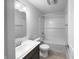 Bright bathroom with a sink, toilet, and a shower-tub combo with white tiling at 6457 Flag Stop Dr, Whitestown, IN 46075