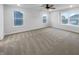 This bedroom features plush carpeting, multiple bright windows, and a ceiling fan at 6457 Flag Stop Dr, Whitestown, IN 46075