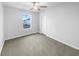 This carpeted bedroom has a ceiling fan, a window, and white walls at 6457 Flag Stop Dr, Whitestown, IN 46075