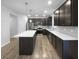 Modern kitchen featuring dark cabinets, stainless steel appliances, and a large center island at 6457 Flag Stop Dr, Whitestown, IN 46075