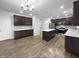 Beautiful kitchen featuring a large island, dark cabinetry, and stainless steel appliances at 6457 Flag Stop Dr, Whitestown, IN 46075