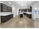 Modern kitchen with stainless steel appliances, dark cabinets, and a large center island at 6457 Flag Stop Dr, Whitestown, IN 46075