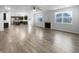 Open-concept living space featuring hardwood floors, large windows, and a modern kitchen at 6457 Flag Stop Dr, Whitestown, IN 46075