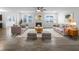 Bright living room with neutral furniture, a cozy fireplace, and ample natural light from large windows at 6457 Flag Stop Dr, Whitestown, IN 46075