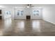 Spacious living room featuring hardwood floors, a fireplace, and large windows for ample natural light at 6457 Flag Stop Dr, Whitestown, IN 46075