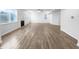 Open-concept living room with hardwood floors, a fireplace, and abundant natural light from large windows at 6457 Flag Stop Dr, Whitestown, IN 46075