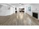 Spacious living room with hardwood floors, fireplace, and an open layout to the kitchen at 6457 Flag Stop Dr, Whitestown, IN 46075