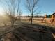 Large fenced backyard featuring a playset and a partially covered patio area at 7018 Allegan Dr, Indianapolis, IN 46217