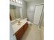 Well-maintained bathroom featuring a single sink vanity, a full mirror, and neutral tones at 7018 Allegan Dr, Indianapolis, IN 46217