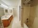 Bathroom with a double sink vanity and a shower and tub combination with tile flooring at 7018 Allegan Dr, Indianapolis, IN 46217