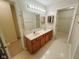Bathroom with a double vanity, a mirror, linoleum floors, and doors to two walk-in closets at 7018 Allegan Dr, Indianapolis, IN 46217