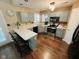 Charming kitchen featuring light blue cabinets, modern appliances, and a breakfast bar area at 7018 Allegan Dr, Indianapolis, IN 46217