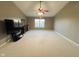 A spacious main bedroom showcases a ceiling fan, neutral carpeting, and lots of natural light at 7018 Allegan Dr, Indianapolis, IN 46217