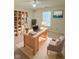 Bright home office featuring a large desk, built-in shelving, and a comfortable chair at 7018 Allegan Dr, Indianapolis, IN 46217