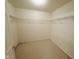 Walk-in closet with neutral carpeting boasts metal shelving on either side for ample storage at 7018 Allegan Dr, Indianapolis, IN 46217