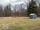 Large backyard with a gray shed, a few small trees, and an open grass area at , Monrovia, IN 46157