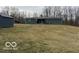 Spacious backyard with a shed on a slight hill and mature trees in the background at , Monrovia, IN 46157