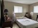 Comfortable bedroom with a neutral color scheme, a window, and classic wood furniture at , Monrovia, IN 46157