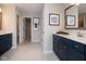 Beautiful primary bathroom featuring double vanities, neutral tiling and modern fixtures at 7348 Deerberg Dr, Indianapolis, IN 46259