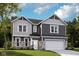 Charming two-story home with stone accents and a two-car garage, perfect for Gathering living at 7348 Deerberg Dr, Indianapolis, IN 46259