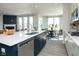 Open-concept kitchen with an island, modern appliances, and a view into the dining area at 7348 Deerberg Dr, Indianapolis, IN 46259