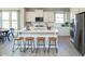 Bright kitchen with white cabinetry, stainless steel appliances, and a center island with bar stools at 7348 Deerberg Dr, Indianapolis, IN 46259