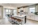 Modern kitchen with white cabinetry, a large center island, and an adjacent dining area at 7348 Deerberg Dr, Indianapolis, IN 46259