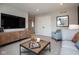 Comfortable living room with a large television, neutral decor, and a modern coffee table at 7348 Deerberg Dr, Indianapolis, IN 46259