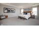 Spacious main bedroom suite with contemporary decor, natural lighting and a seating area at 7348 Deerberg Dr, Indianapolis, IN 46259
