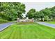 Community entrance featuring water fountain and mature trees at 8221 Furlong Cir, Indianapolis, IN 46256