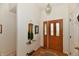 Elegant foyer with a decorative mirror, stylish lighting, and a patterned rug, offering a sophisticated entry at 8221 Furlong Cir, Indianapolis, IN 46256