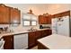 Well-lit kitchen with wooden cabinets, white countertops, and appliances, offering a practical cooking space at 8221 Furlong Cir, Indianapolis, IN 46256
