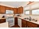 Bright kitchen with wooden cabinetry, white appliances, and a functional layout at 8221 Furlong Cir, Indianapolis, IN 46256