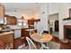 Functional kitchen features wood cabinets, white appliances, and an adjacent breakfast nook at 8221 Furlong Cir, Indianapolis, IN 46256