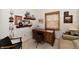 Home office with a wooden desk, shelving, and comfortable seating area at 8221 Furlong Cir, Indianapolis, IN 46256