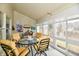 Sunroom features comfortable chairs, a table, and lots of natural light at 8221 Furlong Cir, Indianapolis, IN 46256