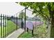 Well-maintained community tennis court with rules posted and surrounded by lush greenery at 8221 Furlong Cir, Indianapolis, IN 46256