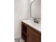 Bathroom vanity featuring dark wood cabinets and decorative black and white tile flooring at 9318 Drawbridge Ct, Indianapolis, IN 46250