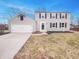 Charming two-story home features an attached garage, neutral siding, and well-maintained landscaping at 9318 Drawbridge Ct, Indianapolis, IN 46250
