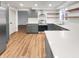 Modern kitchen with stainless steel appliances, floating shelves, and ample counter space for cooking at 9318 Drawbridge Ct, Indianapolis, IN 46250