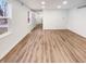 Bright living room showcasing updated flooring, white walls, and multiple windows for an airy and inviting space at 9318 Drawbridge Ct, Indianapolis, IN 46250
