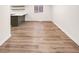Bright living room showing new flooring and view of the modern kitchen with white countertops at 9318 Drawbridge Ct, Indianapolis, IN 46250